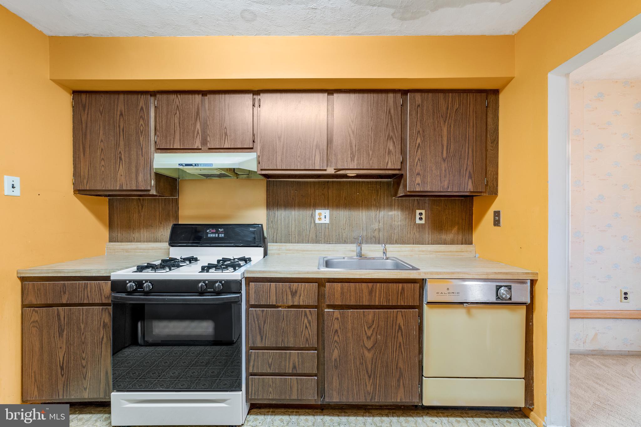 803 Timber Creek Road Clementon, NJ 08021 - Photo 6 of 26 a kitchen with a stove and a microwave