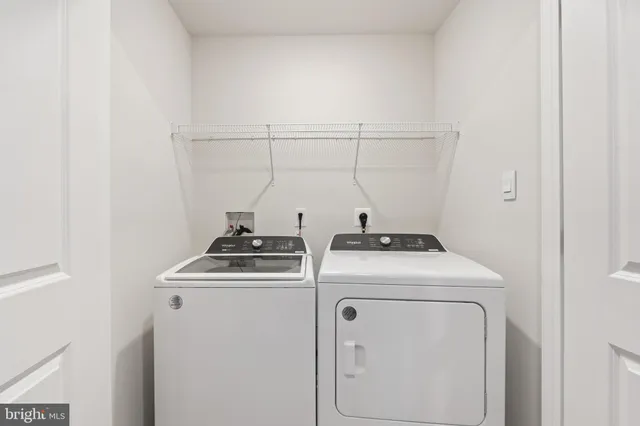 a view of storage and utility room with washer and dryer