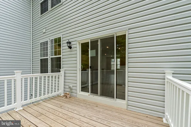 a view of a house with wooden deck