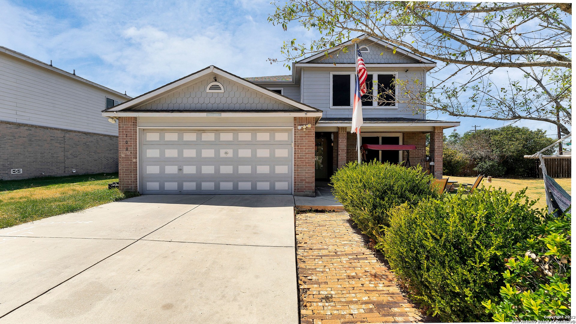 100 Bridge Crossing Cibolo, TX 78108 - Photo 1 of 1 a front view of a house with a yard and garage