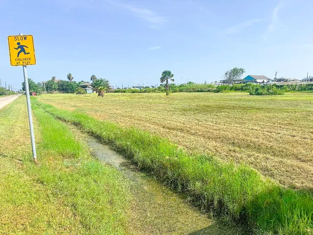a view of a field with an ocean view