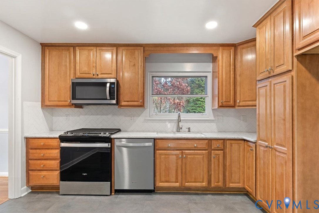 2502 Landon Road Richmond, VA 23294 - Photo 12 of 26 a kitchen with stainless steel appliances granite countertop a stove a sink and a microwave