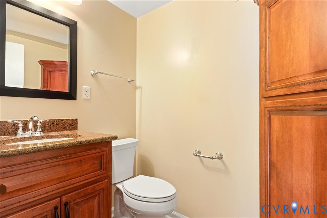 2502 Landon Road Richmond, VA 23294 - Photo 20 of 26 a bathroom with a granite countertop sink toilet and mirror