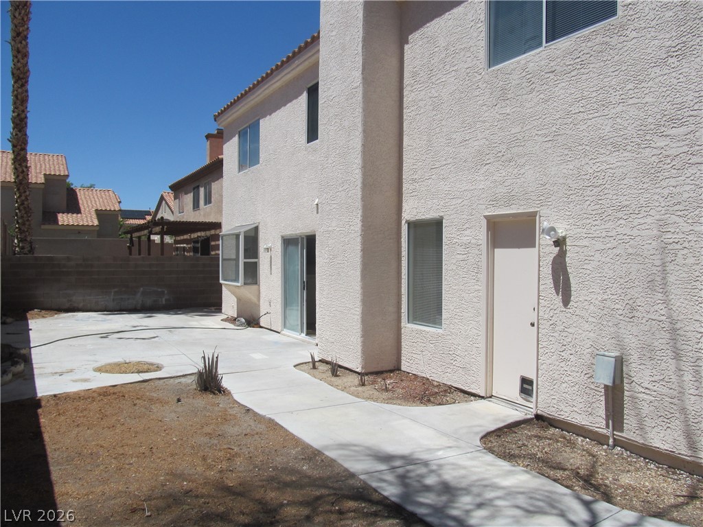 8701 Crescent Ridge Lane Las Vegas, NV 89134 - Photo 25 of 28 A private yard with ample concrete patio space offers an outdoor retreat.