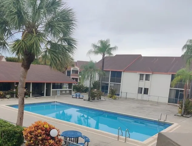 a view of a house with swimming pool and sitting area