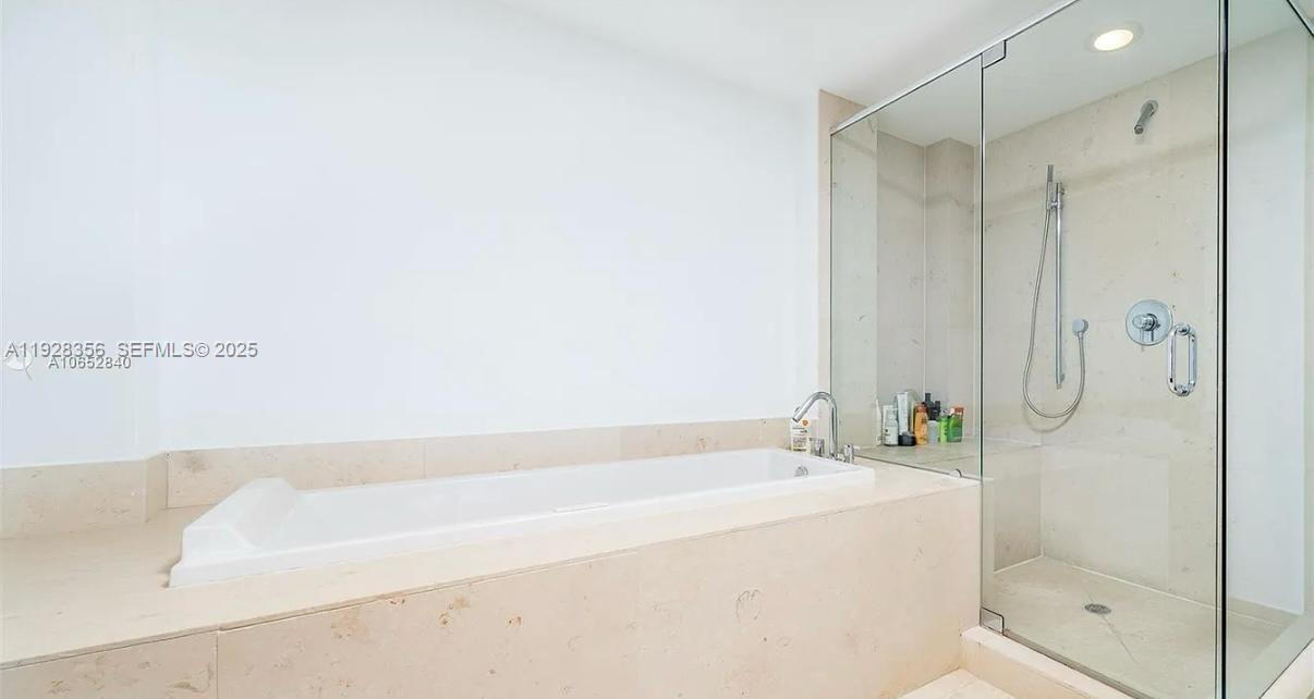 475 Brickell Avenue, Unit 5707 Miami, FL 33131 - Photo 13 of 16 a bathroom with a bathtub and a shower