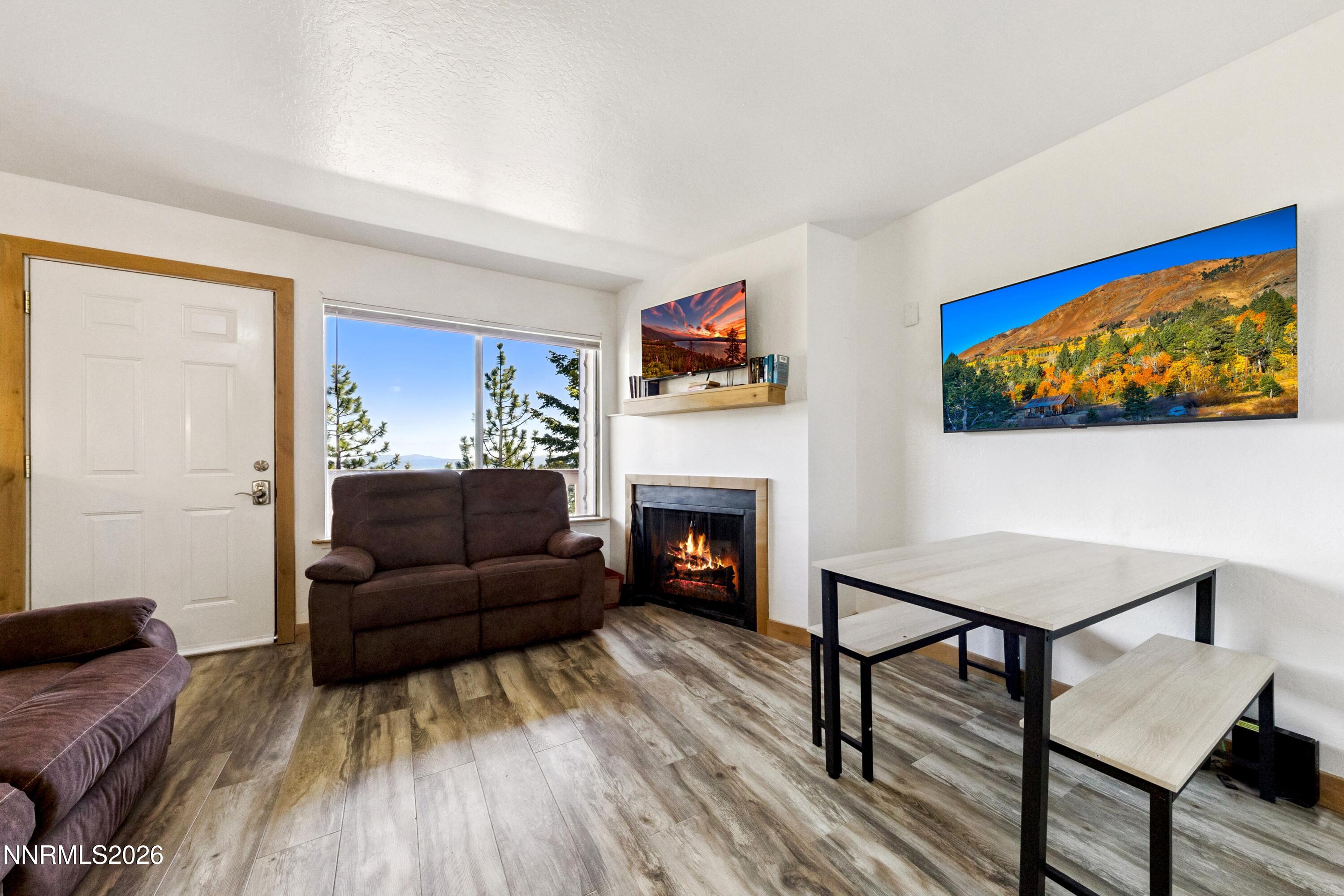 261 Quaking Aspen Lane, Unit D Stateline, NV 89449 - Photo 25 of 44 a living room with furniture a flat screen tv and a fireplace