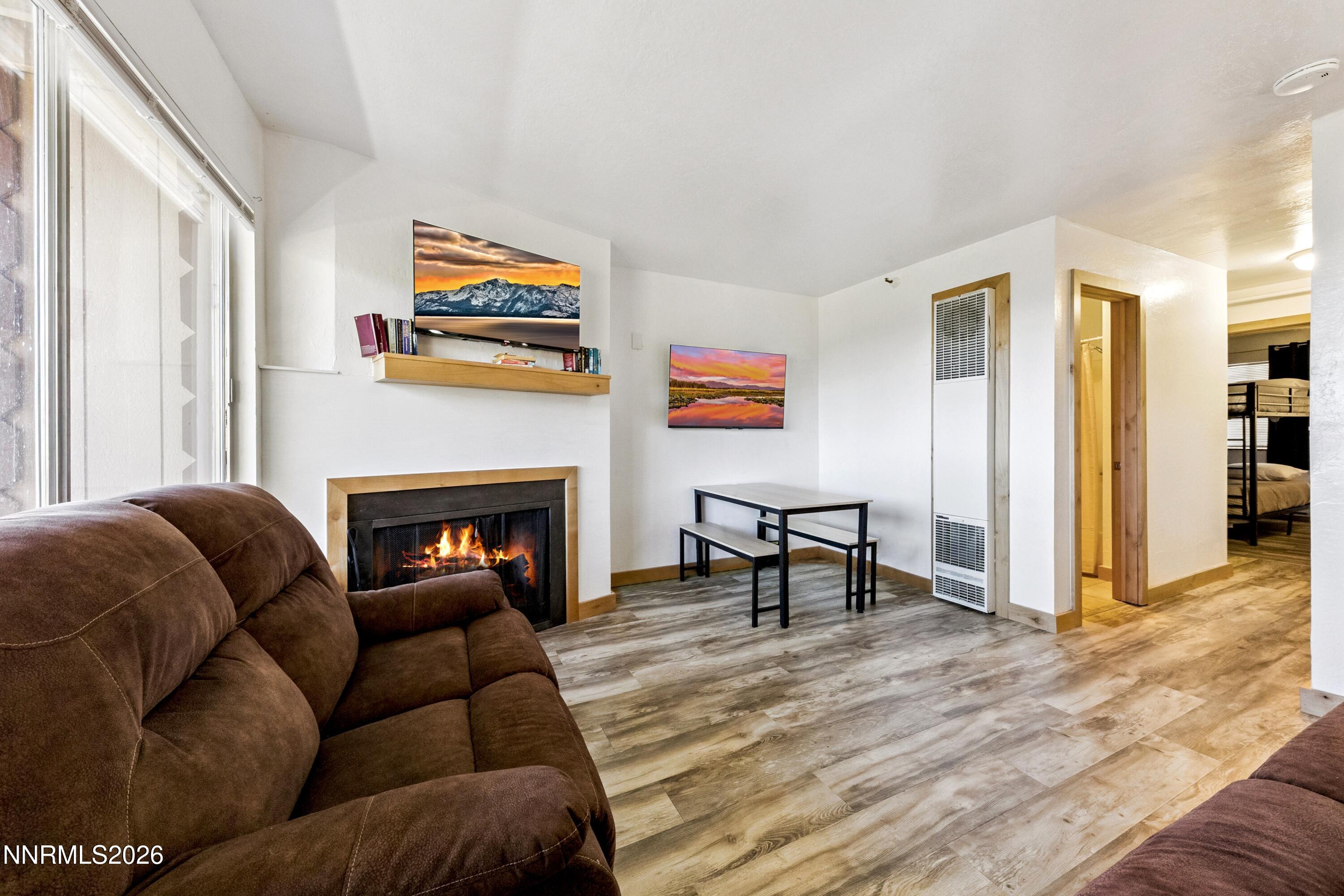 261 Quaking Aspen Lane, Unit D Stateline, NV 89449 - Photo 26 of 44 a living room with furniture and a fireplace