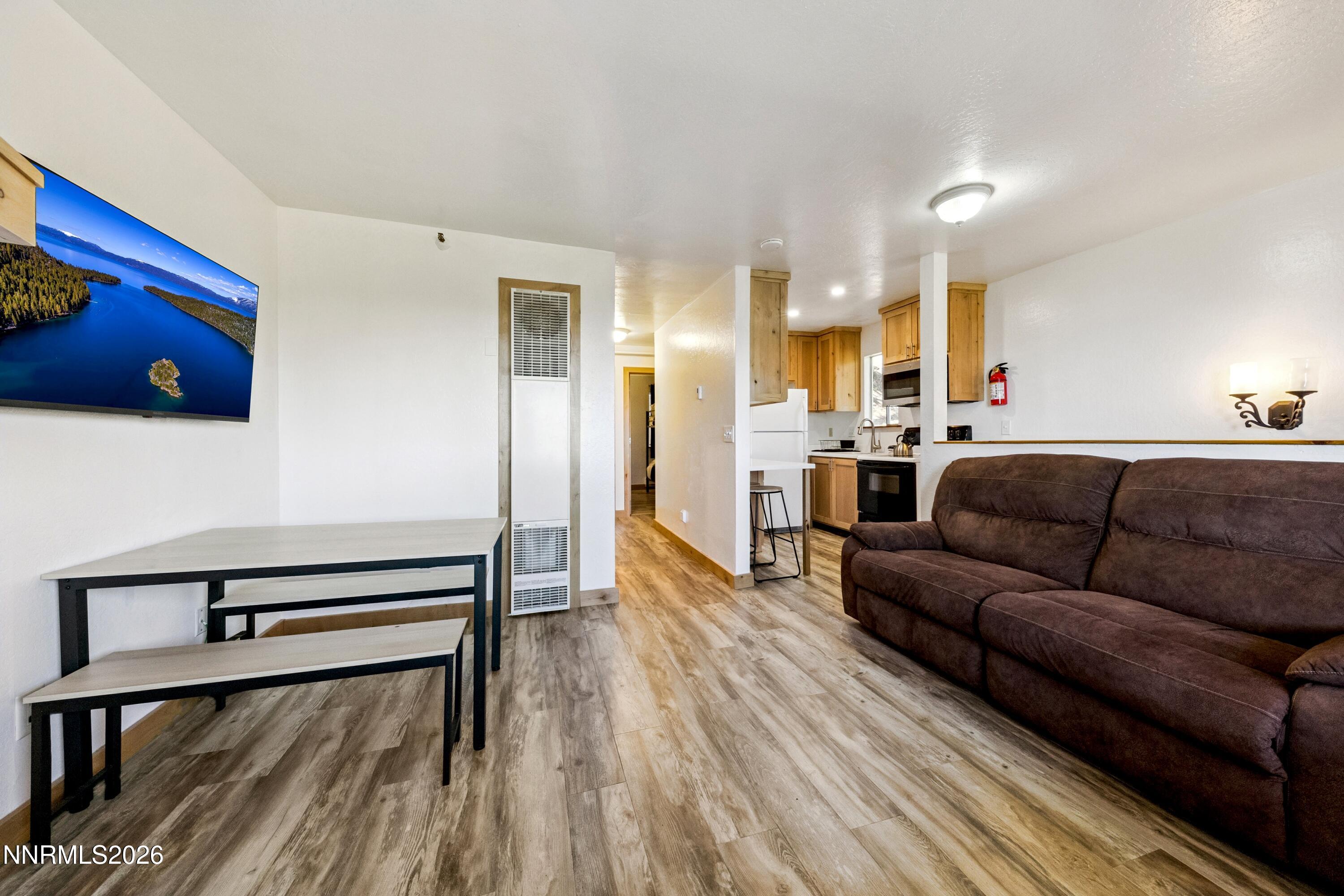 261 Quaking Aspen Lane, Unit D Stateline, NV 89449 - Photo 27 of 44 a living room with furniture and a flat screen tv