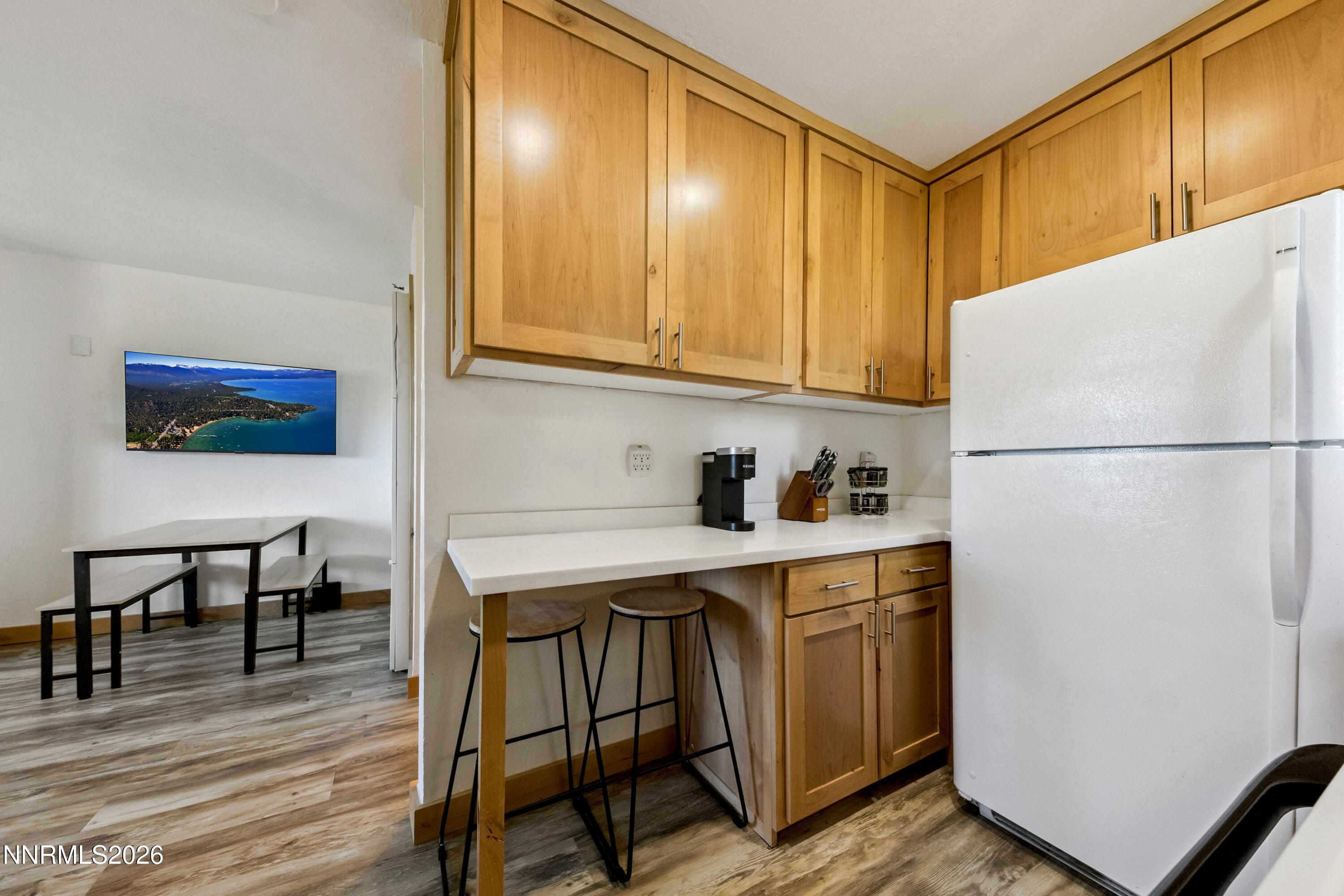 261 Quaking Aspen Lane, Unit D Stateline, NV 89449 - Photo 28 of 44 a kitchen with a refrigerator a stove a sink and cabinets