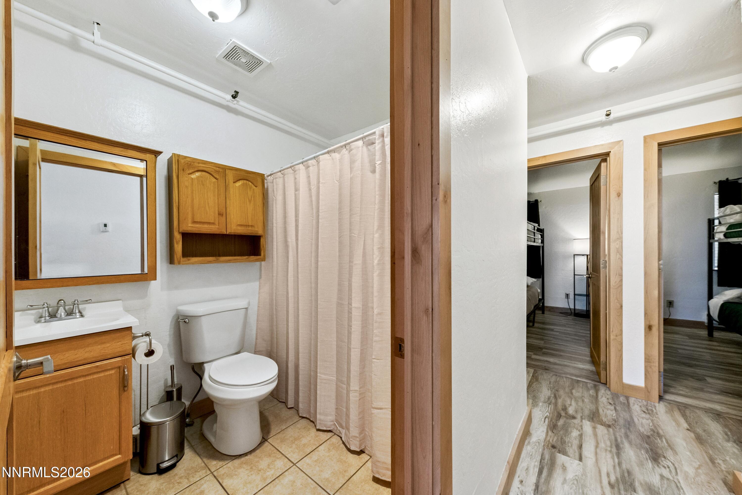 261 Quaking Aspen Lane, Unit D Stateline, NV 89449 - Photo 32 of 44 a bathroom with a toilet sink shower and mirror
