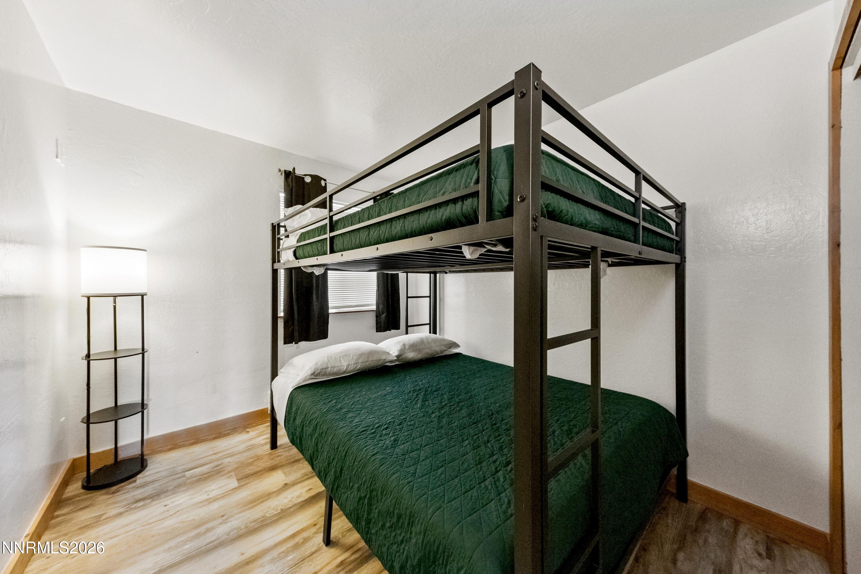 261 Quaking Aspen Lane, Unit D Stateline, NV 89449 - Photo 35 of 44 a bedroom with a bed and a window