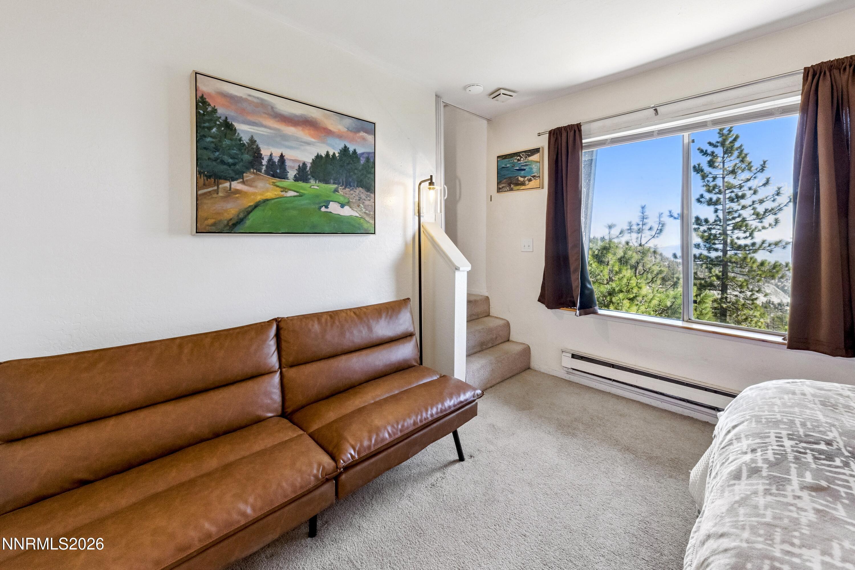 261 Quaking Aspen Lane, Unit D Stateline, NV 89449 - Photo 38 of 44 a living room with furniture and a large window