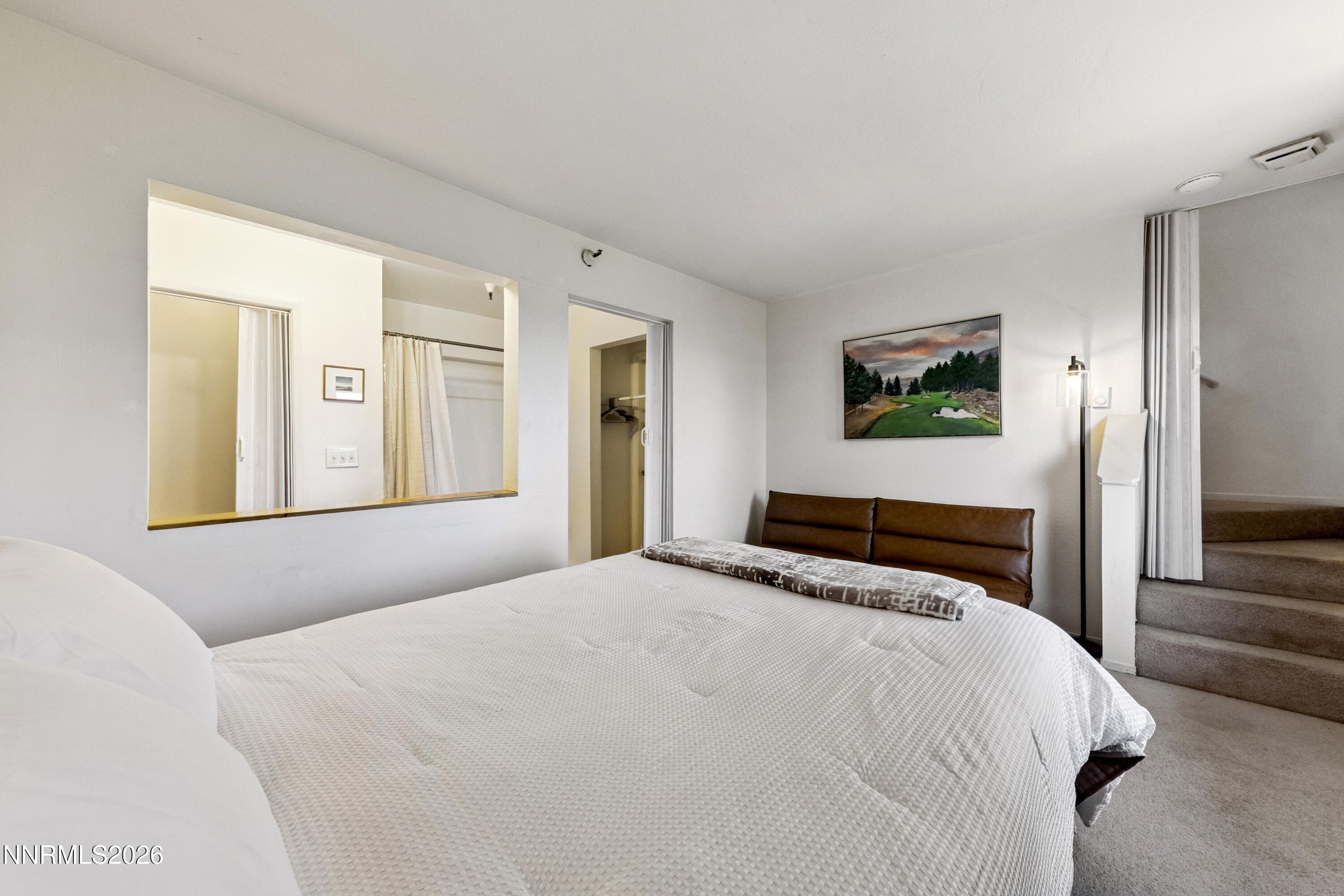 261 Quaking Aspen Lane, Unit D Stateline, NV 89449 - Photo 41 of 44 a bedroom with a bed and a painting on the wall