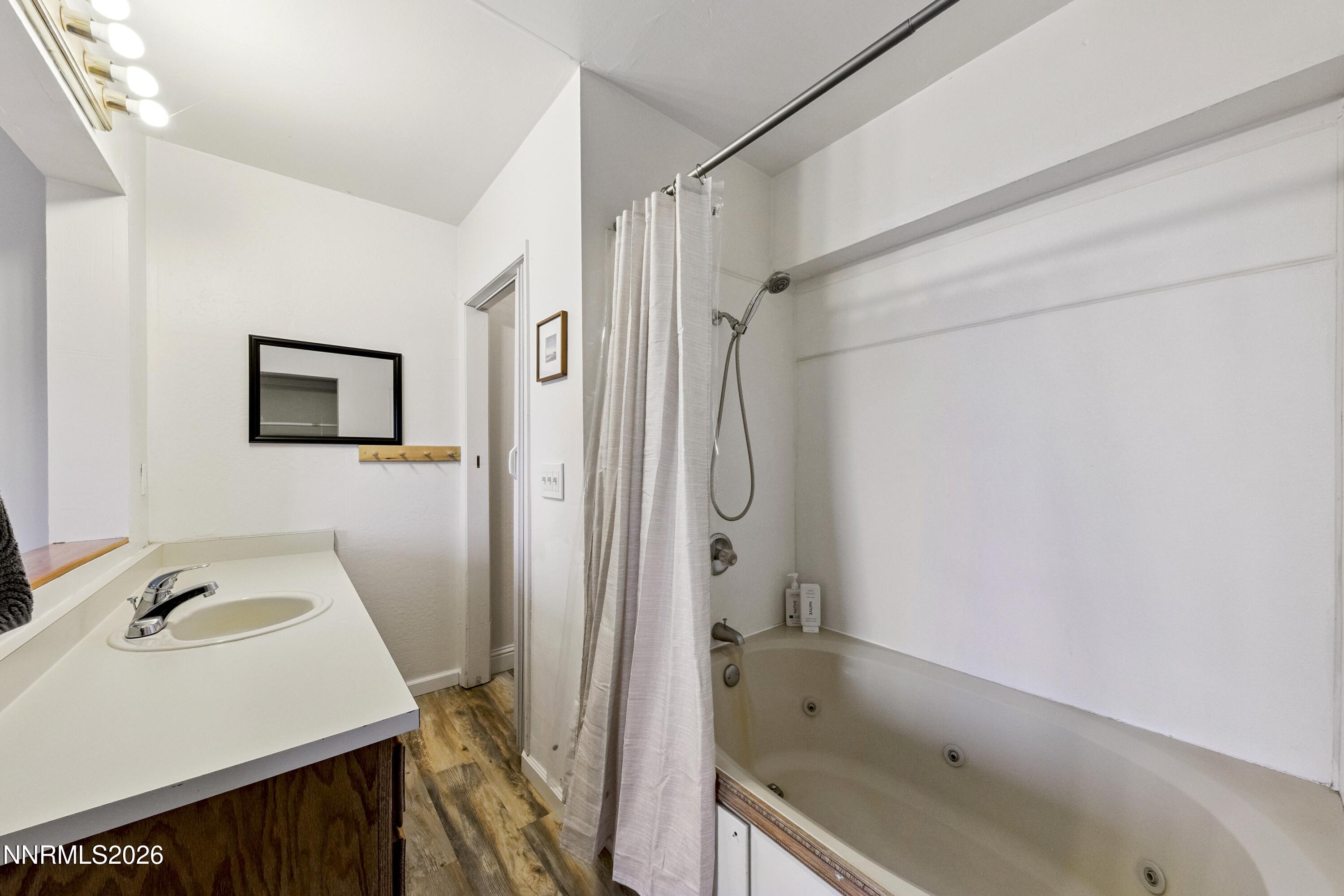 261 Quaking Aspen Lane, Unit D Stateline, NV 89449 - Photo 43 of 44 a bathroom with a bathtub and a sink