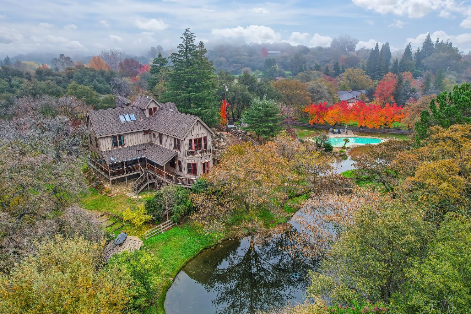 an aerial view of a house with a garden and trees