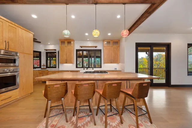 a kitchen with stainless steel appliances granite countertop a refrigerator and a sink