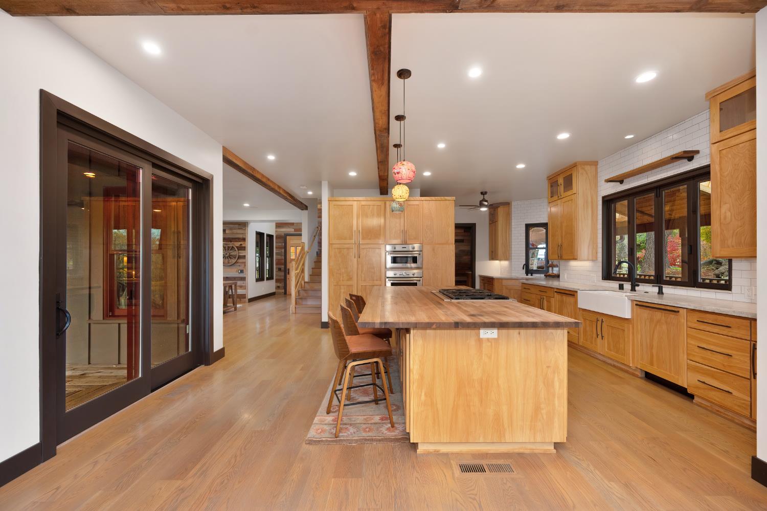 9475 King Road Loomis, CA 95650 - Photo 15 of 96 a view of a kitchen with kitchen island stainless steel appliances wooden floor dining table and chairs