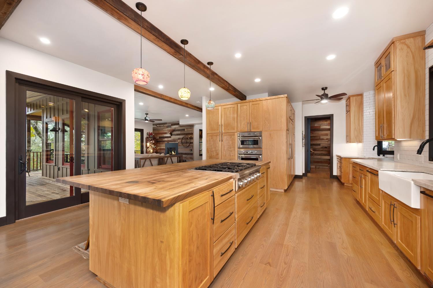 9475 King Road Loomis, CA 95650 - Photo 16 of 96 a large kitchen with stainless steel appliances kitchen island a large counter top and a view of living room