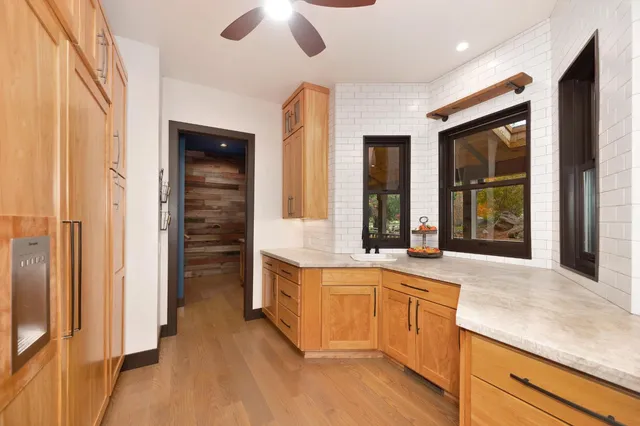 a bedroom with furniture and a large window
