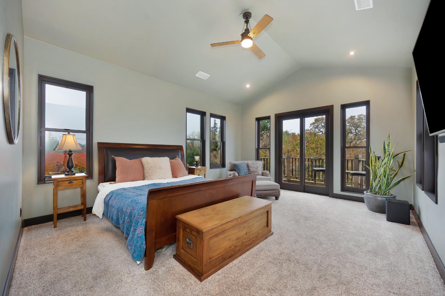 9475 King Road Loomis, CA 95650 - Photo 35 of 96 a spacious bedroom with a large bed and a chandelier fan