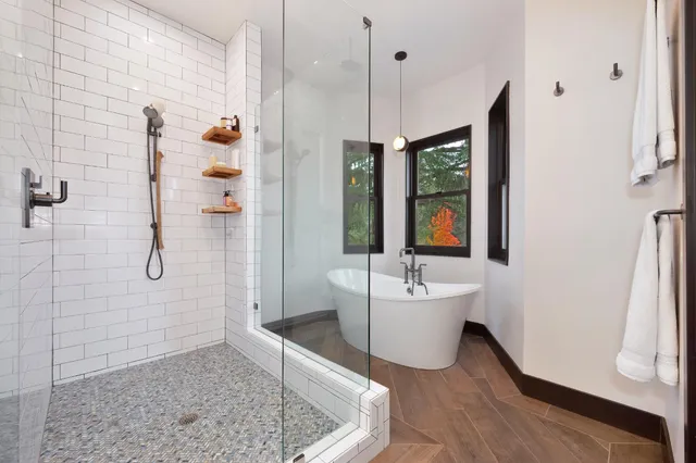 a kitchen with granite countertop a dining table chairs refrigerator and sink