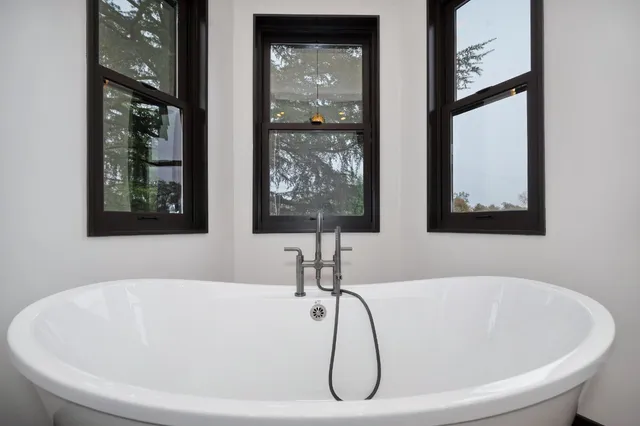 a kitchen with stainless steel appliances granite countertop a kitchen island hardwood floor and a sink
