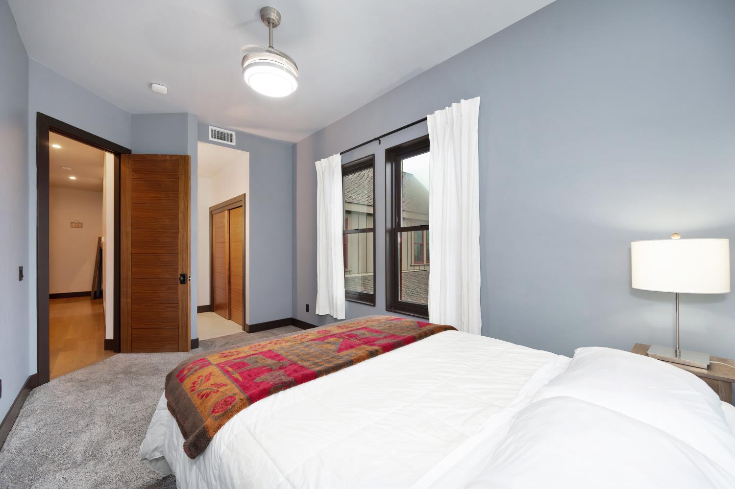 9475 King Road Loomis, CA 95650 - Photo 44 of 96 a bedroom with a large bed and a chandelier