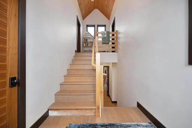 an aerial view of a house with a yard and lake view