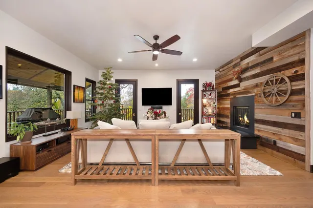 a large kitchen with stainless steel appliances kitchen island a large counter top and a view of living room