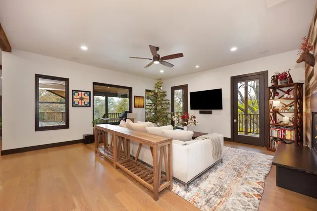 a kitchen with a stove and a view of living room