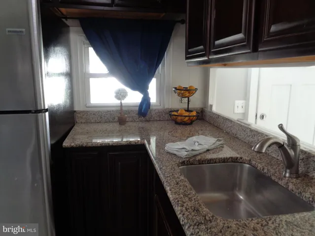 a kitchen with sink and refrigerator