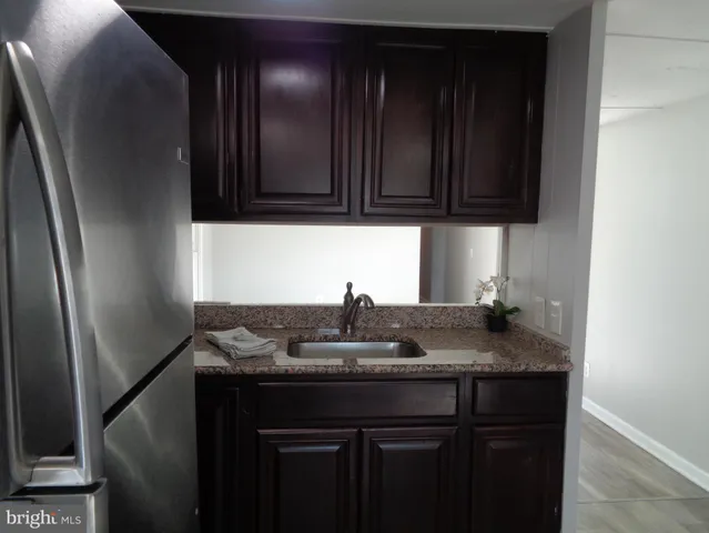 a kitchen with granite countertop wood cabinets and a granite counter tops