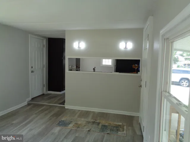 a view of a livingroom with an empty space and a window