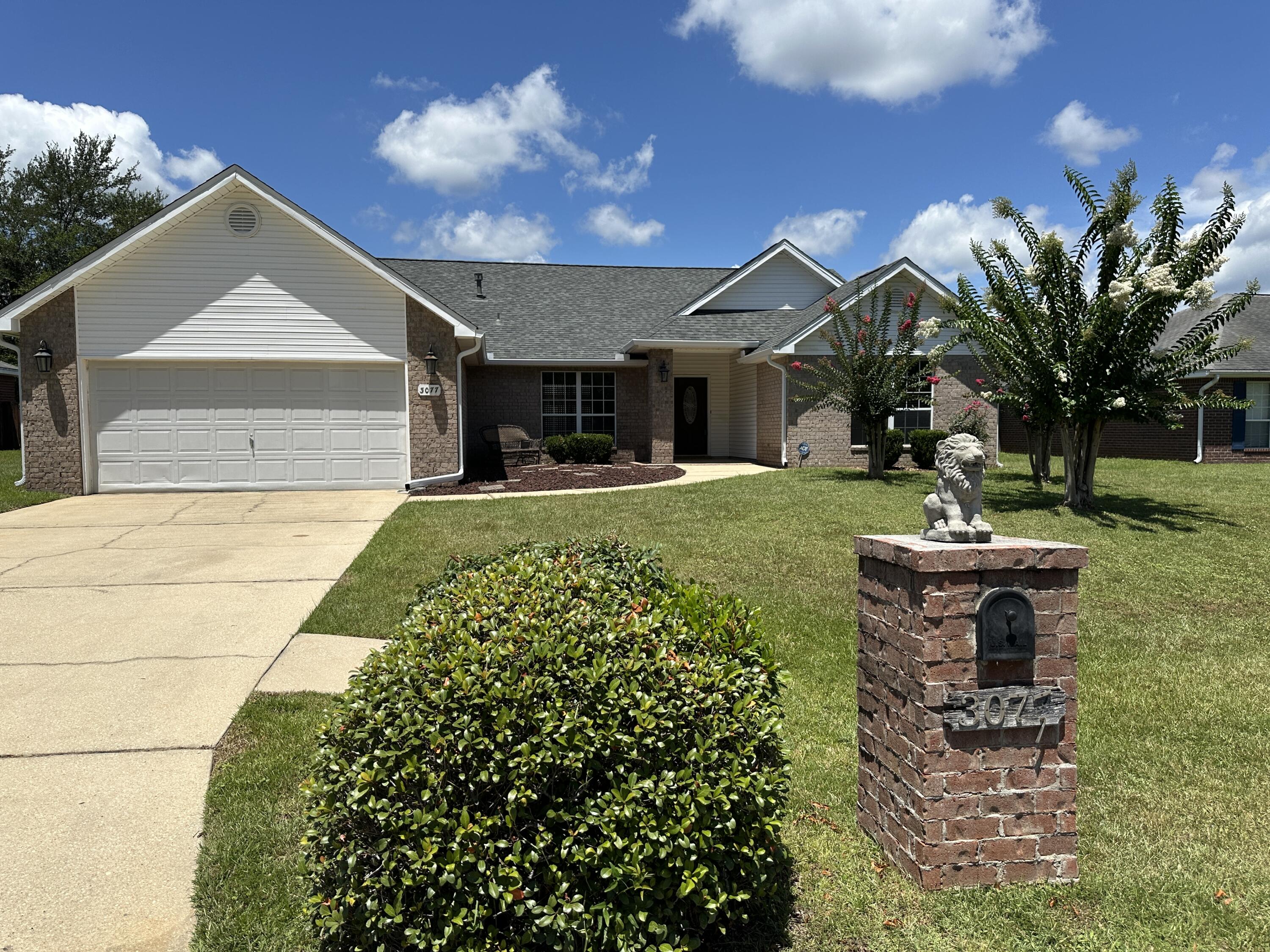 3077 Border Creek Drive Crestview, FL 32539 - Photo 1 of 33 a front view of a house with garden