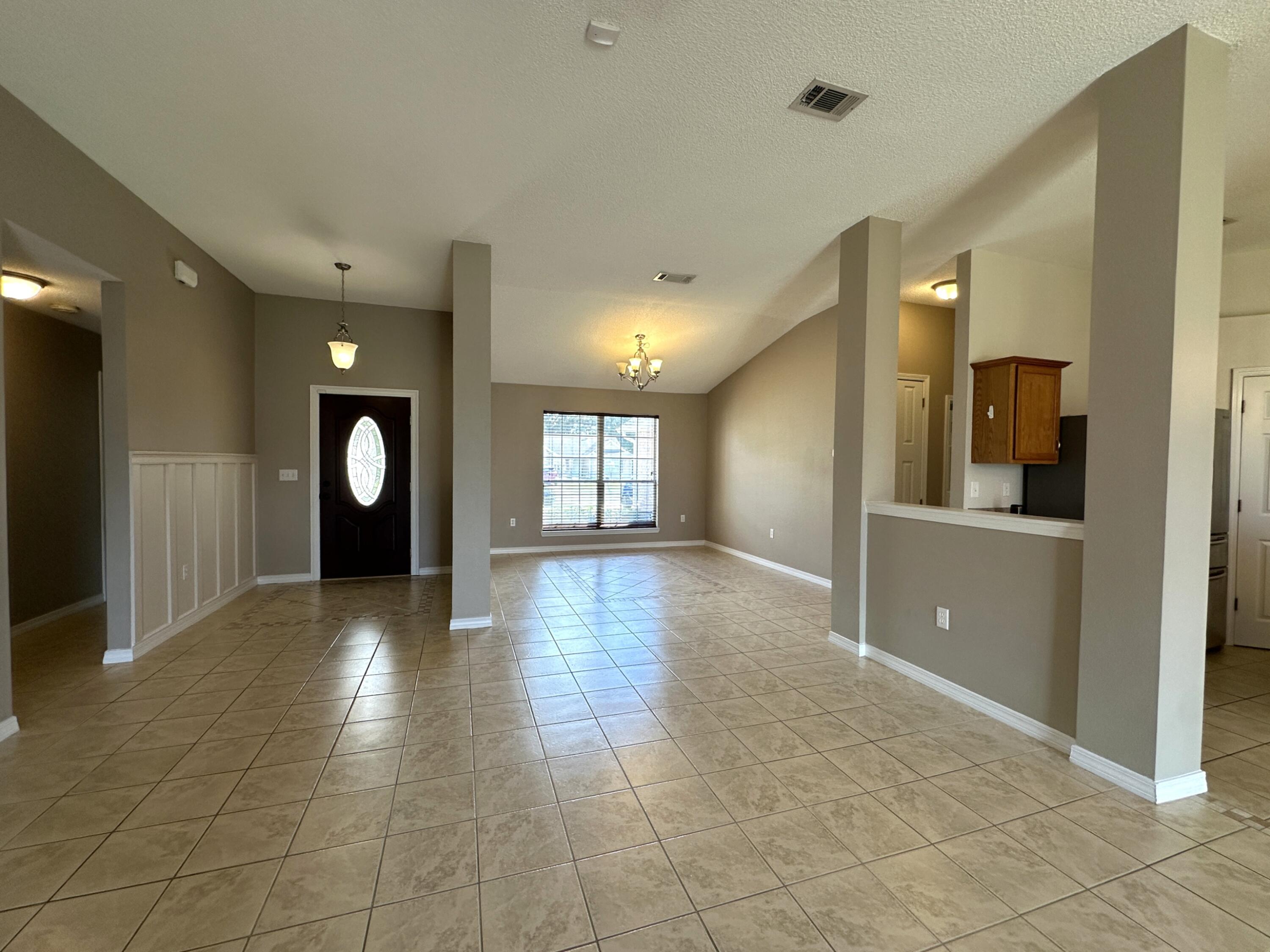 3077 Border Creek Drive Crestview, FL 32539 - Photo 13 of 33 a view of a hallway with wooden floor and a large window