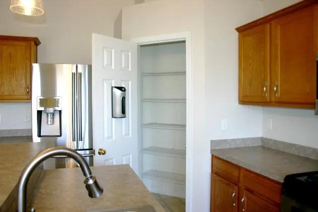 a kitchen with a refrigerator and cabinets