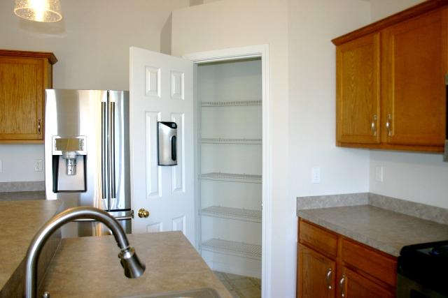 3077 Border Creek Drive Crestview, FL 32539 - Photo 14 of 33 a kitchen with a refrigerator and cabinets