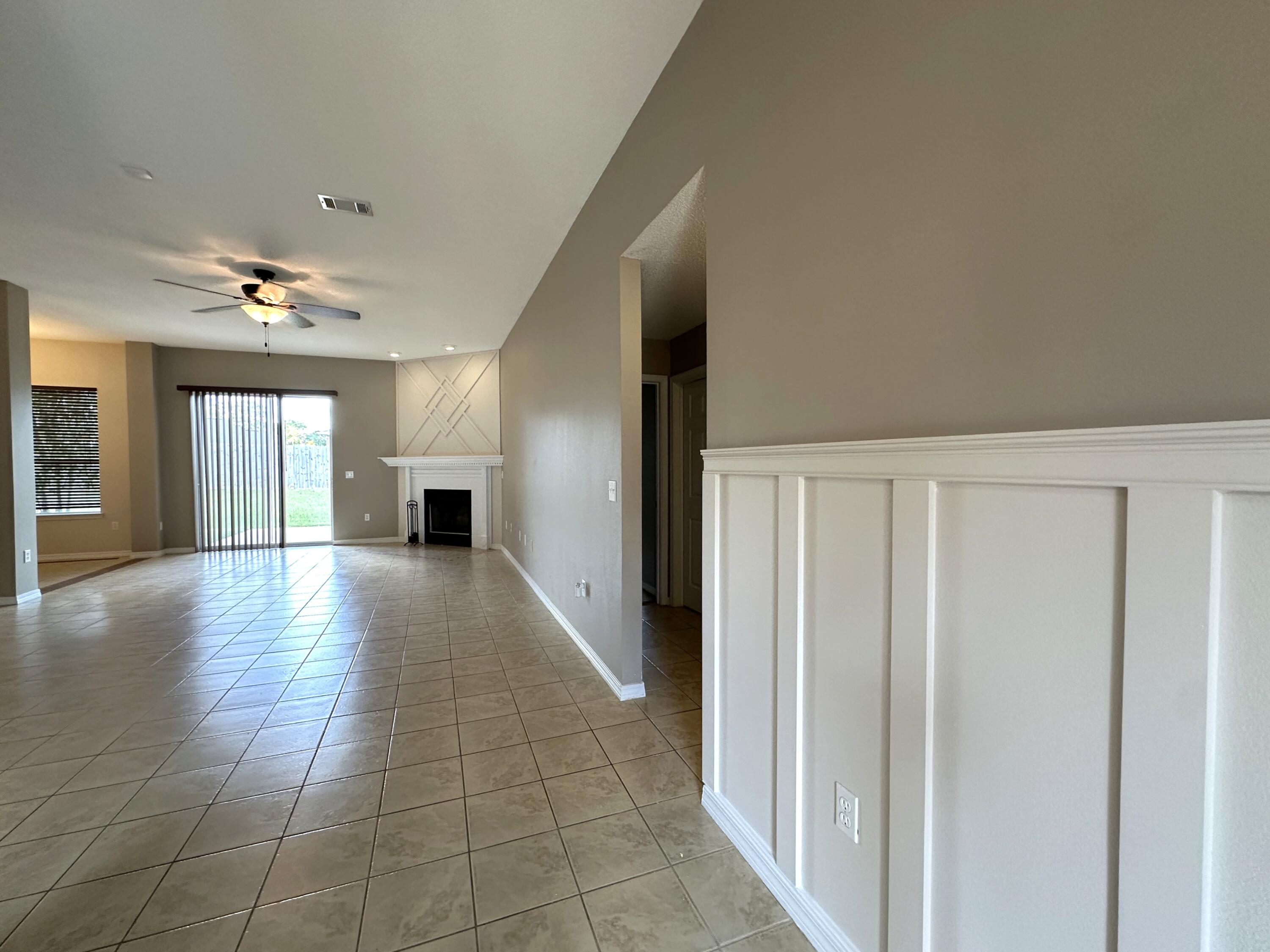 3077 Border Creek Drive Crestview, FL 32539 - Photo 16 of 33 a view of a hallway with wooden floor and windows