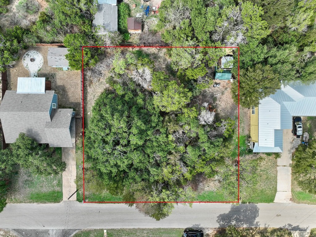 an aerial view of a house with a yard and tree s