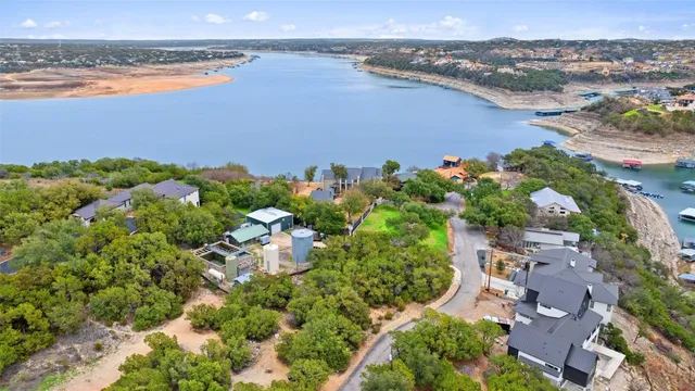 an aerial view of multiple house with a lake view