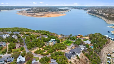 an aerial view of a houses with a lake