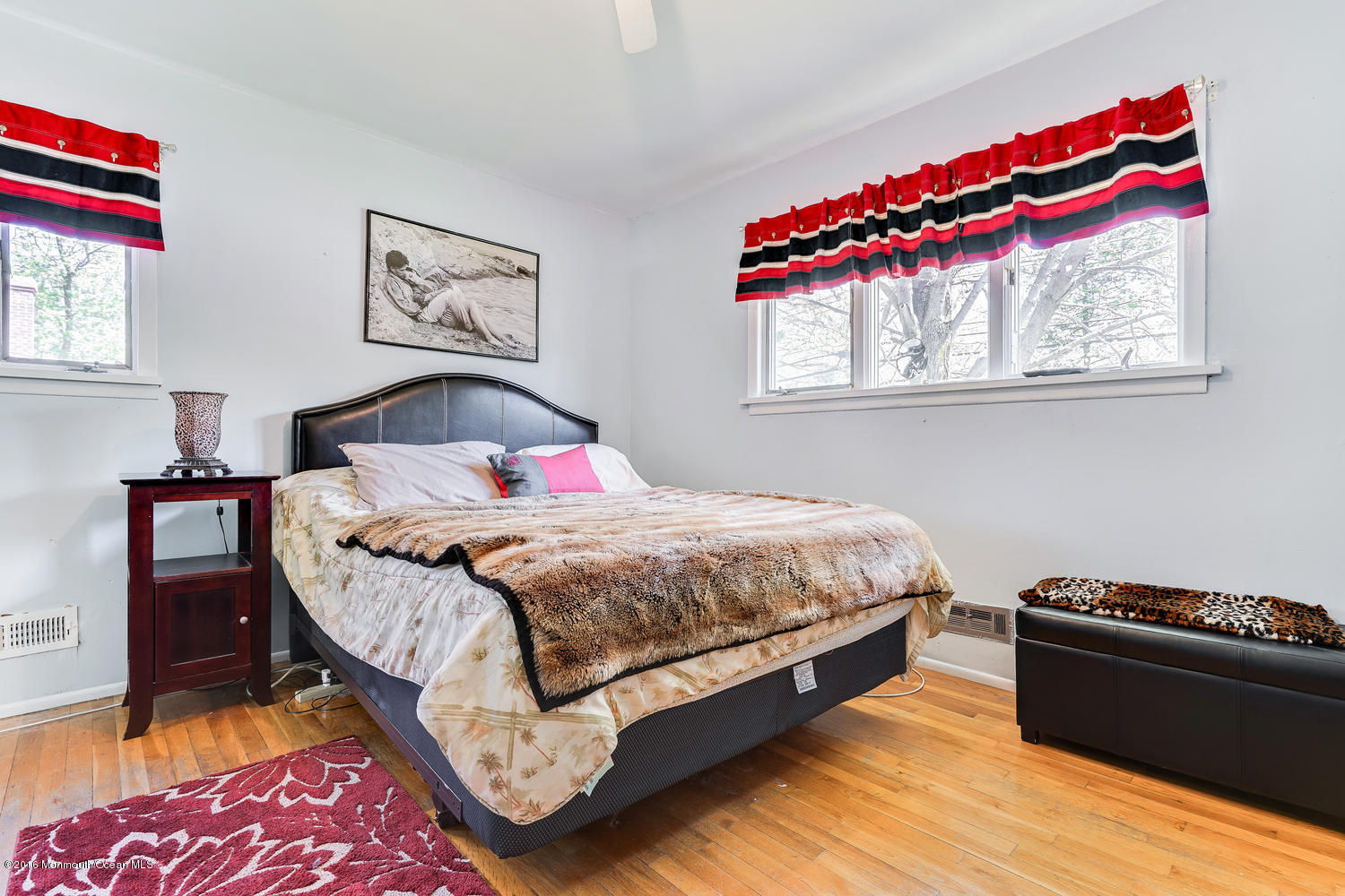 9 Chestnut Ridge Road Holmdel, NJ 07733 - Photo 27 of 39 a bedroom with a bed and wooden floor