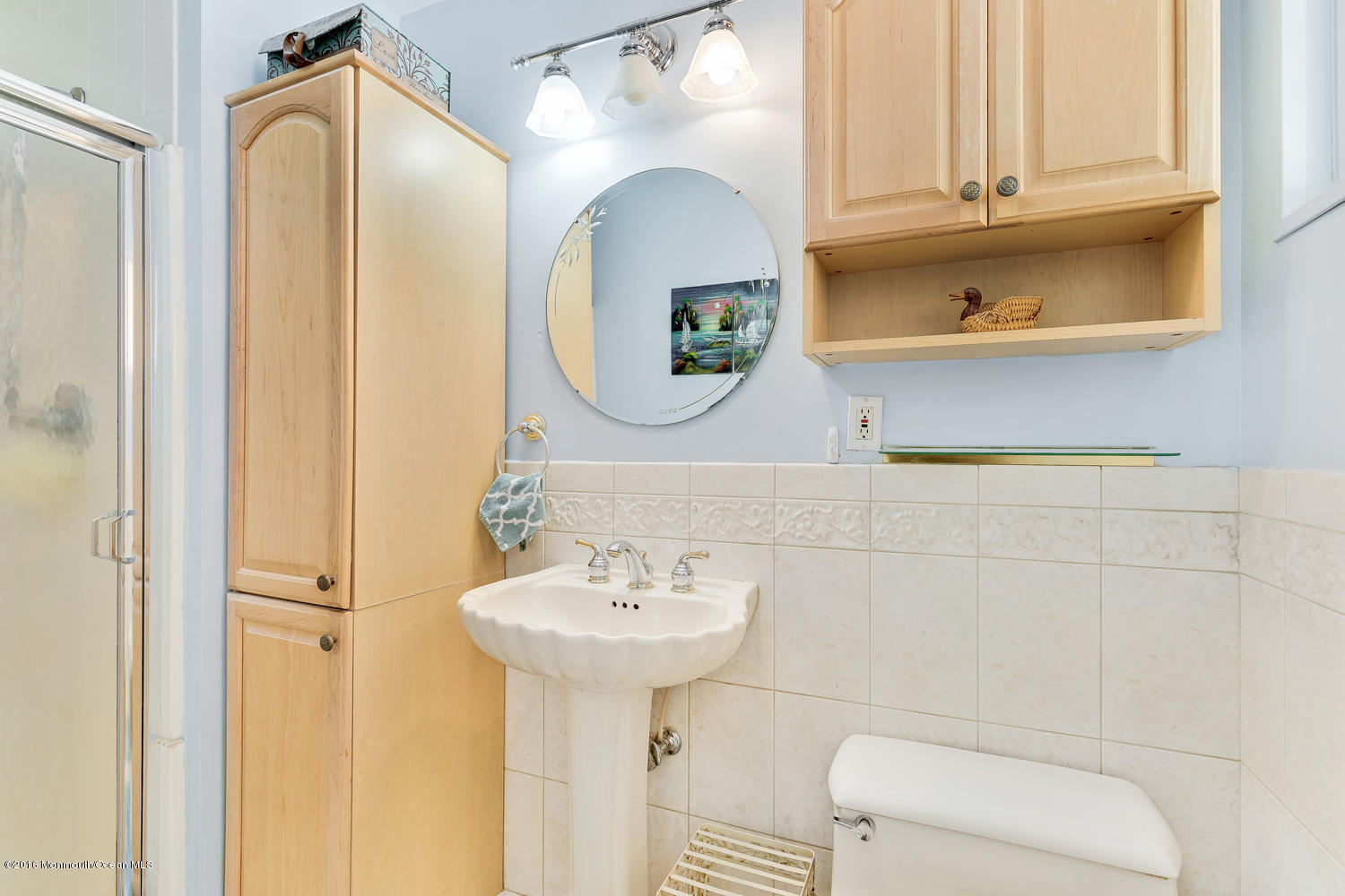 9 Chestnut Ridge Road Holmdel, NJ 07733 - Photo 29 of 39 a bathroom with a sink toilet and mirror