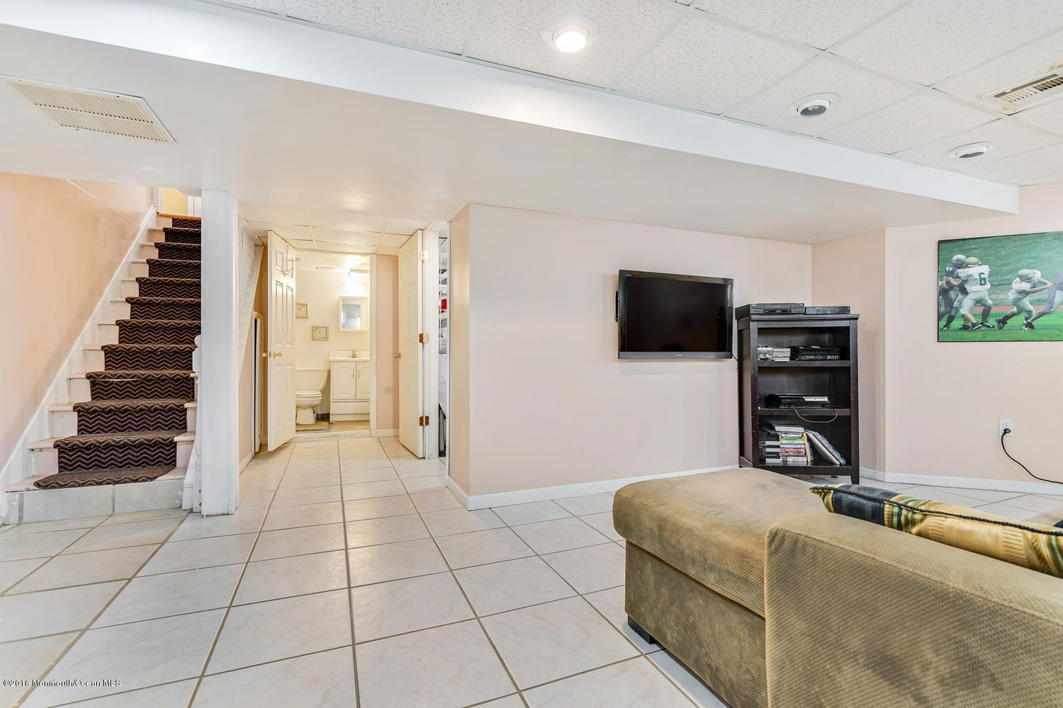 9 Chestnut Ridge Road Holmdel, NJ 07733 - Photo 30 of 39 a living room with furniture and a flat screen tv