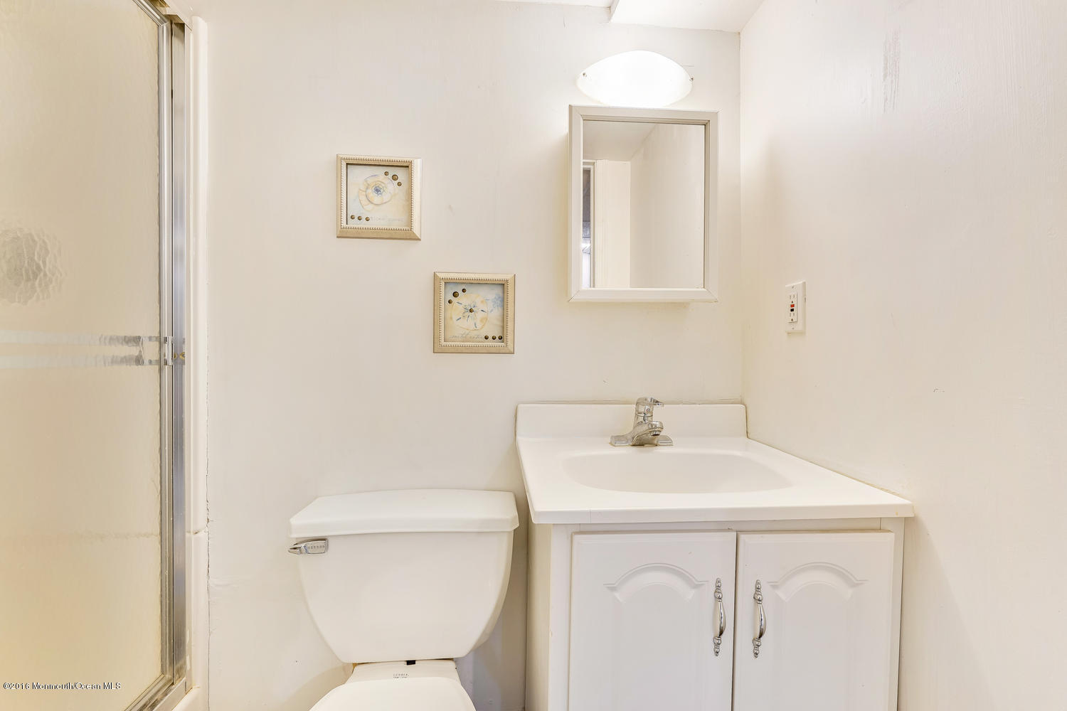 9 Chestnut Ridge Road Holmdel, NJ 07733 - Photo 31 of 39 a bathroom with a sink a toilet and a mirror