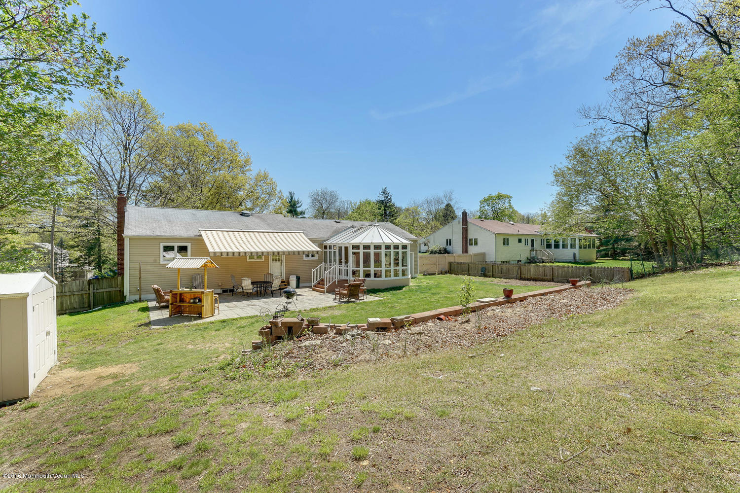 9 Chestnut Ridge Road Holmdel, NJ 07733 - Photo 37 of 39 a view of a house with a yard and sitting area