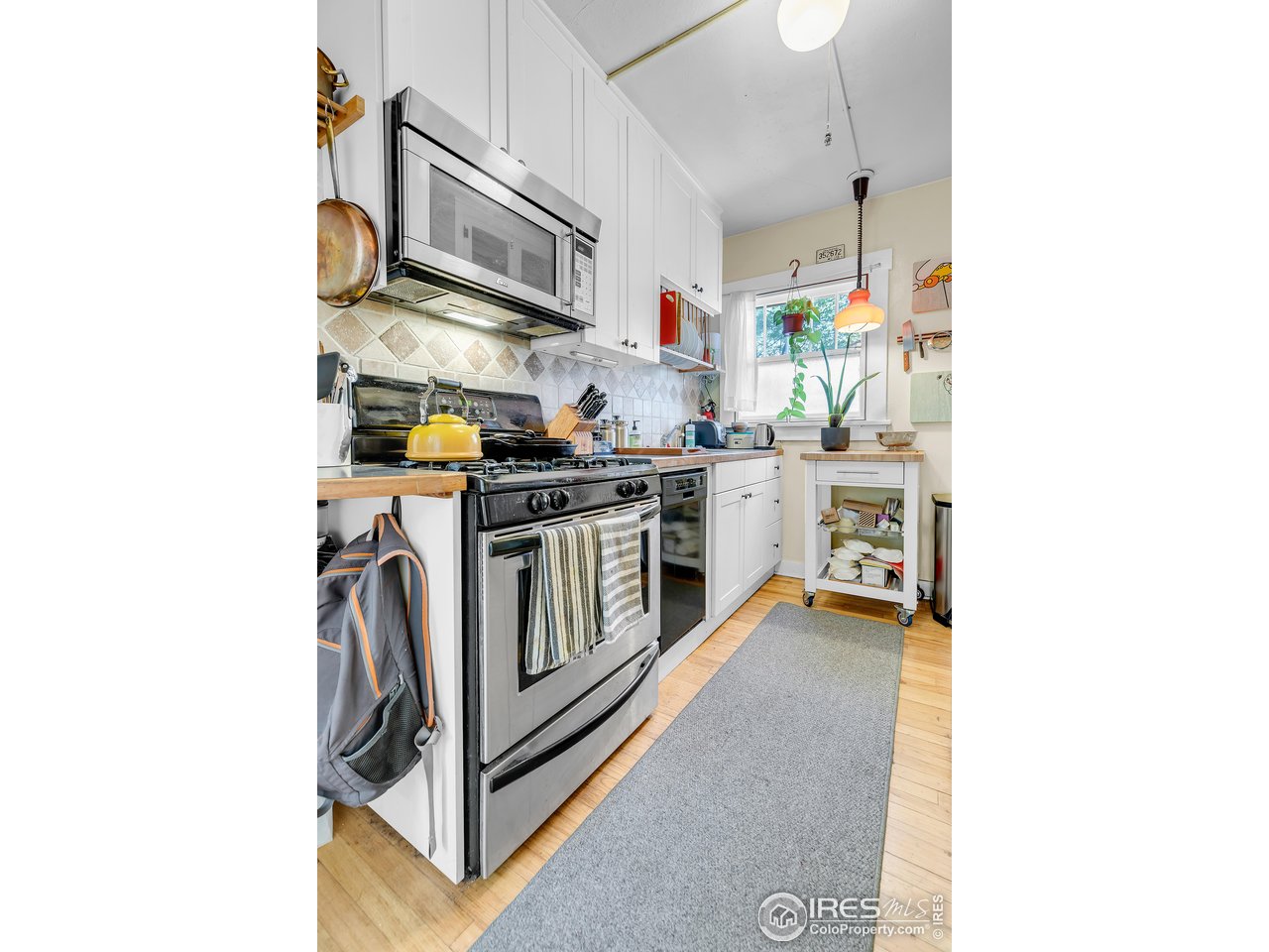 834-836 13th Street Boulder, CO 80302 - Photo 8 of 40 a kitchen with stainless steel appliances granite countertop a stove and a microwave