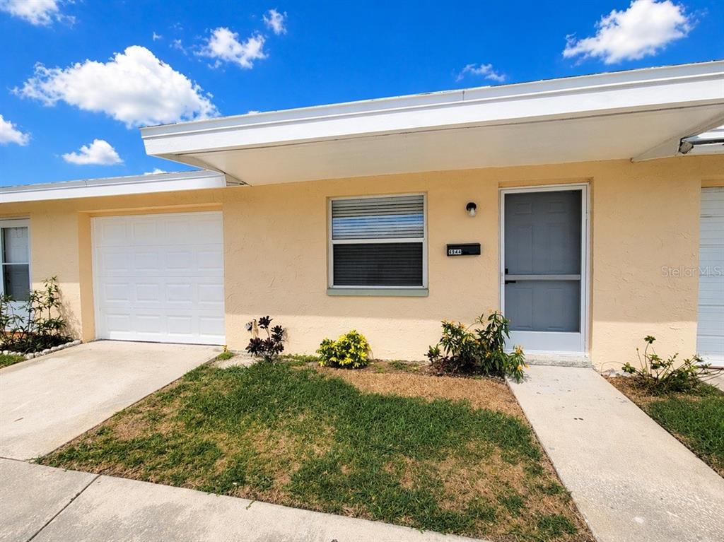 4944 Elkner Street New Port Richey, FL 34652 - Photo 2 of 24 a front view of a house with a yard