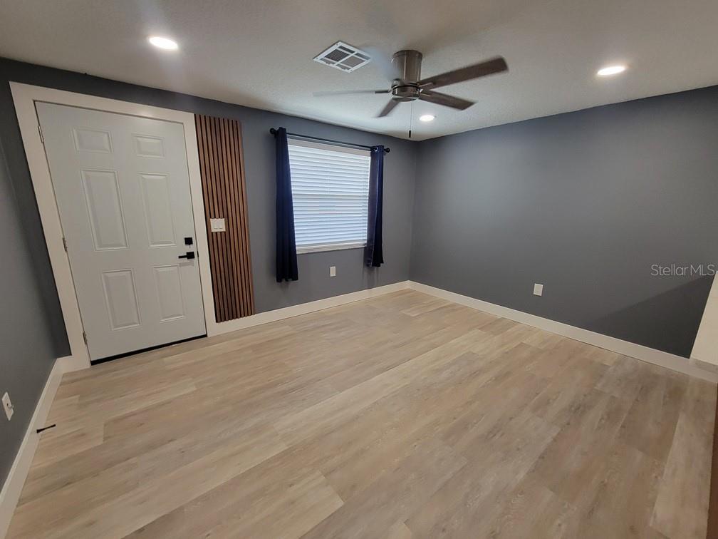 4944 Elkner Street New Port Richey, FL 34652 - Photo 3 of 24 a view of a livingroom with a ceiling fan and window